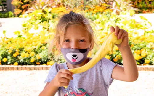 a girl holding a banana