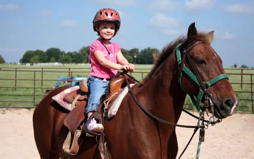 a girl riding a horse