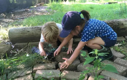 two children playing with rocks