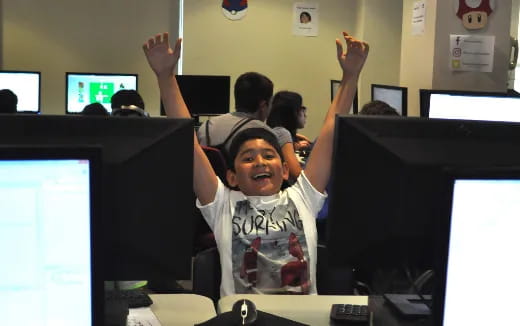 a boy raising his hands