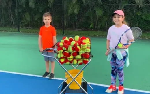 kids holding tennis rackets