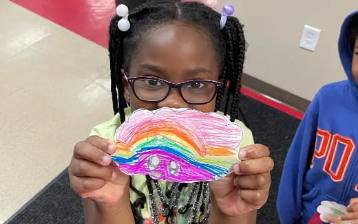 a girl holding a cupcake