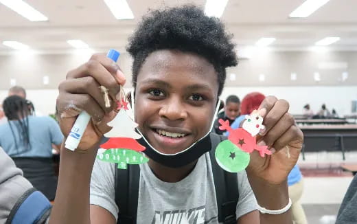 a boy holding a toy